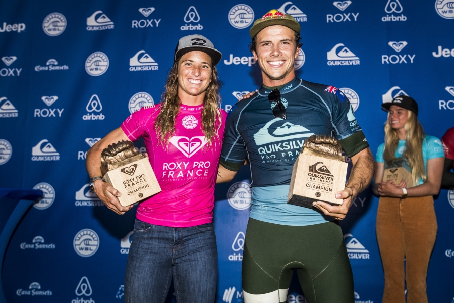 Caption: Courtney Conlogue (USA) and Julian Wilson (AUS) celebrate their wins at the 2018 Roxy Pro and Quiksilver Pro France.  Credit: © WSL / Poullenot