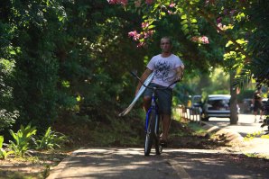 Ruben Gonzalez pedala a caminho do surf no North Shore Havaiano